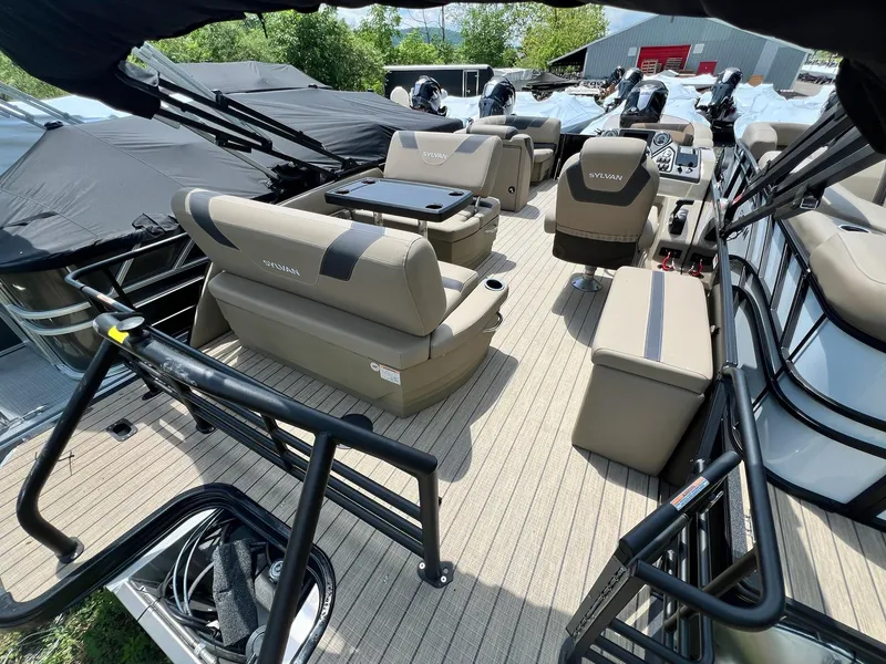 Slide: The Image of 2025 Sylvan L1 DLZ pontoon boat interior with beige seating and modern design. - 3
