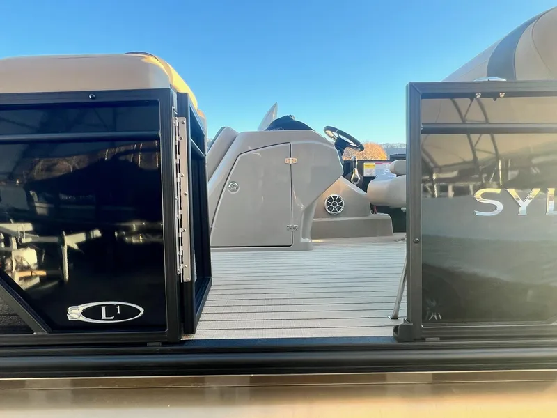 Slide: The Image of 2025 Sylvan L1 DLZ pontoon boat interior with steering console and seating. - 30