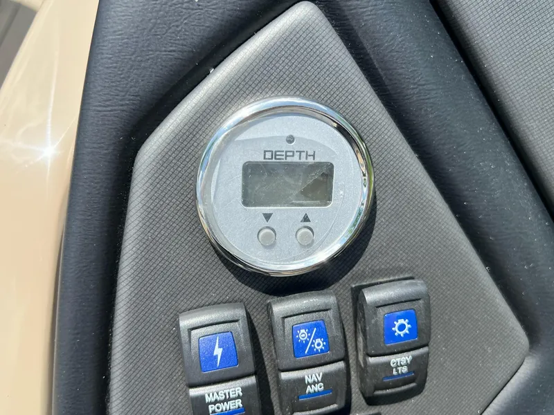 Slide: The Image of 2025 Sylvan L1 DLZ boat dashboard with depth gauge and control switches. - 34