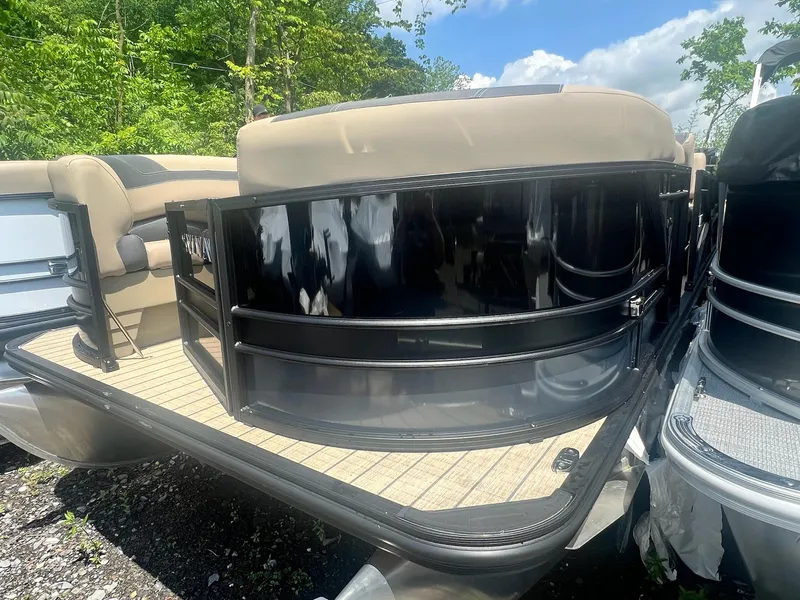 Slide: The Image of 2025 Sylvan L1 DLZ pontoon boat with sleek black railing and beige seating. - 37