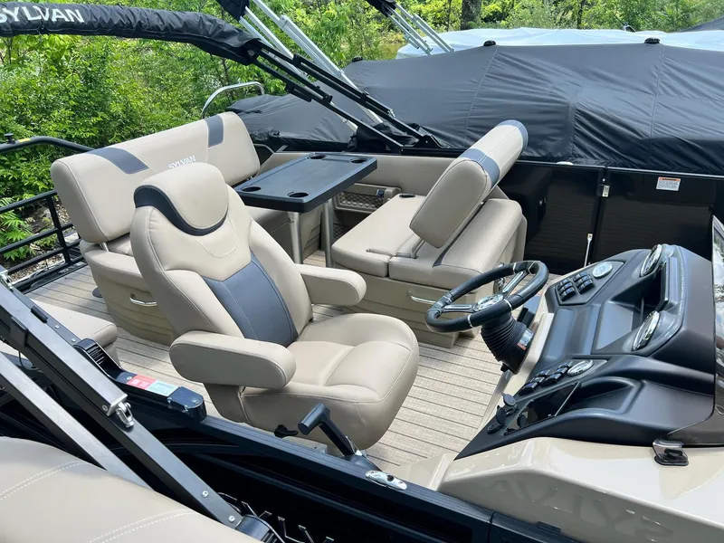 Slide: The Image of 2025 Sylvan L1 DLZ boat interior with luxurious seating and modern dashboard. - 39