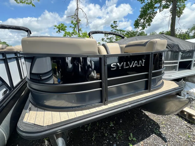 Slide: The Image of 2025 Sylvan L1 DLZ pontoon boat with beige seating, parked outdoors. - 41