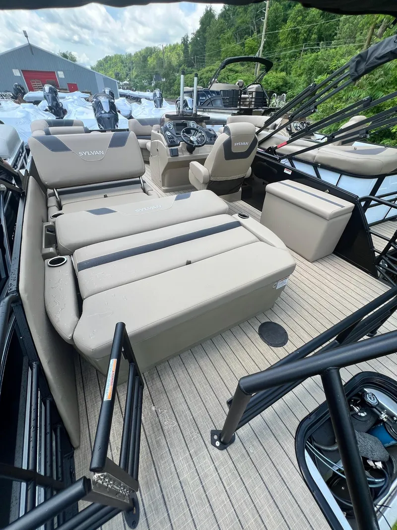 Slide: The Image of 2025 Sylvan L1 DLZ boat interior with beige seating and modern controls. - 45