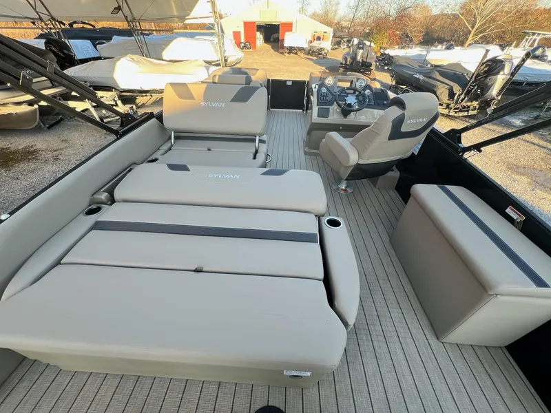 Slide: The Image of 2025 Sylvan L1 DLZ boat interior with beige seating and modern dashboard. - 48