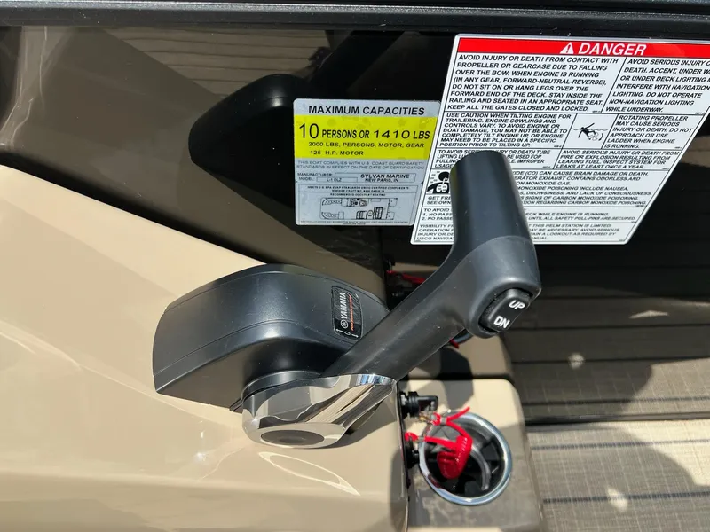 Slide: The Image of Close-up of 2025 Sylvan L1 DLZ boat throttle and capacity warning labels. - 7