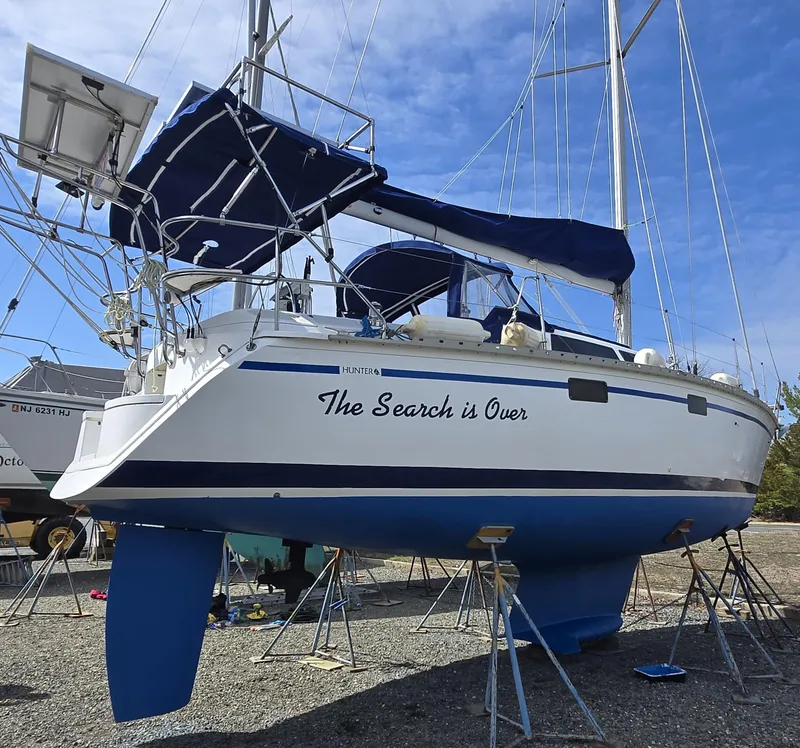 Slide: The Image of Hunter 33.5 sailboat from 1994 named "The Search is Over" on dry dock. - 1