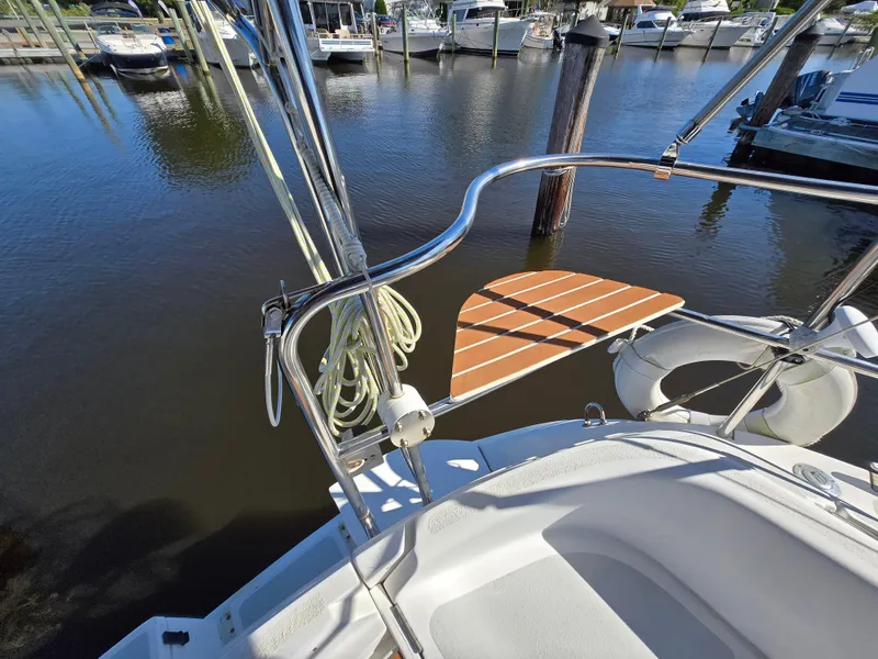 Slide: The Image of Hunter 33.5 sailboat deck, 1994 model, docked at marina with water view. - 14
