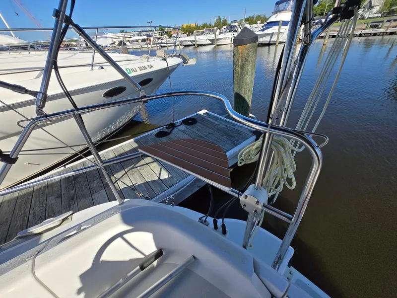Slide: The Image of 1994 Hunter 33.5 sailboat docked at marina, featuring deck and railing details. - 15