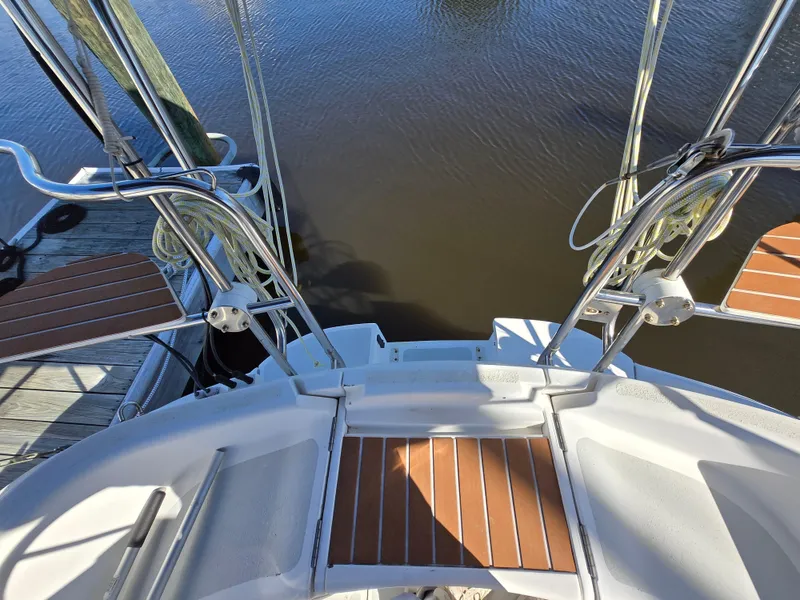 Slide: The Image of Hunter 33.5 sailboat stern view, 1994 model, docked with wooden deck details. - 16