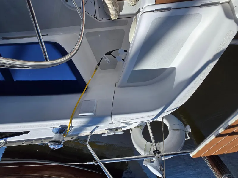 Slide: The Image of 1994 Hunter 33.5 sailboat deck with lifebuoy and railing, docked at marina. - 17