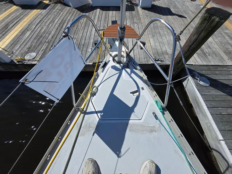 Slide: The Image of Bow of a 1994 Hunter 33.5 sailboat docked at a marina. - 25