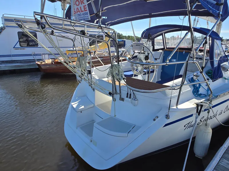Slide: The Image of 1994 Hunter 33.5 sailboat docked, featuring a spacious cockpit and "For Sale" sign. - 29