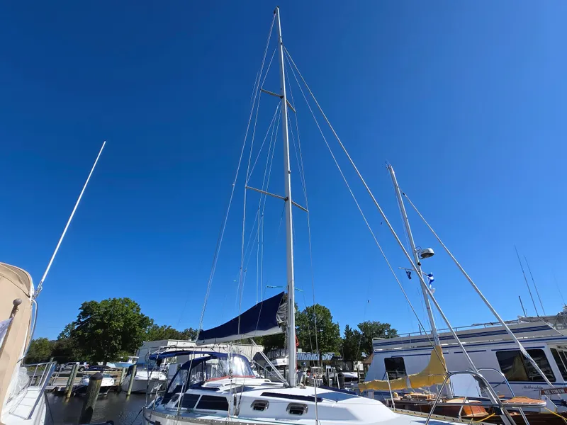 Slide: The Image of Hunter 33.5 sailboat from 1994 docked under clear blue sky. - 32