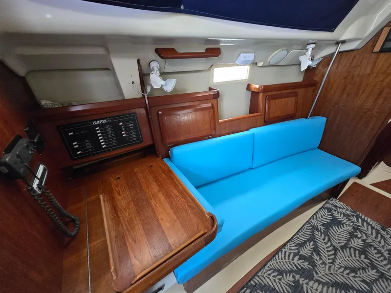 Slide: The Image of Interior of 1994 Hunter 33.5 sailboat with blue seating and wooden cabinetry. - 36