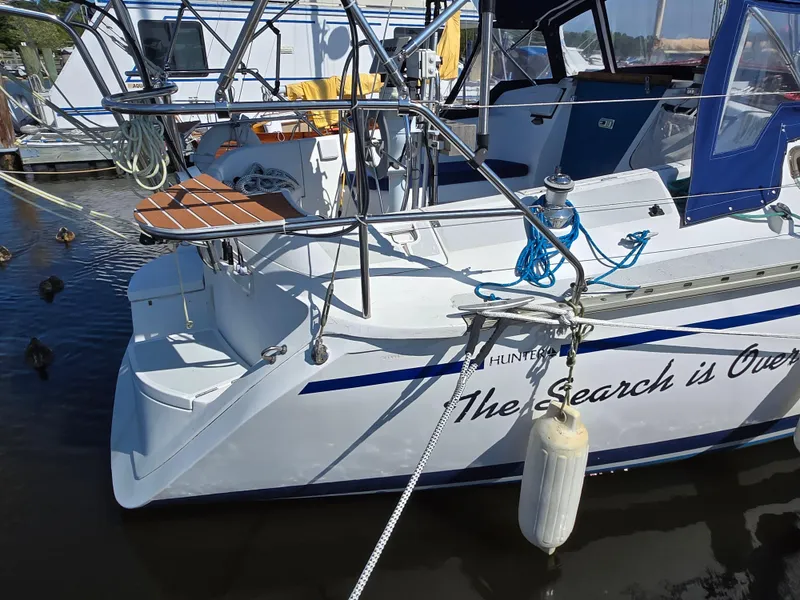 Slide: The Image of 1994 Hunter 33.5 sailboat docked, featuring "The Search is Over" text on the side. - 7