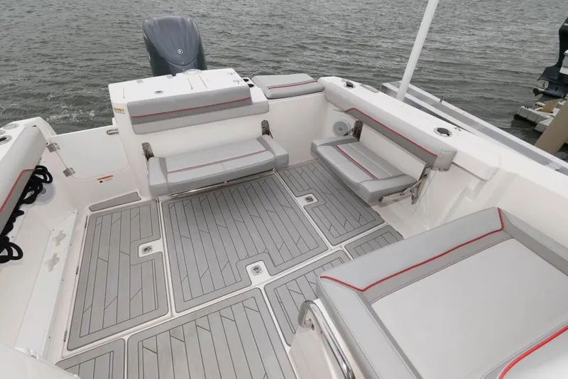 Slide: The Image of 2023 Solara S-250 DC boat interior with gray seating and deck, on water. - 10