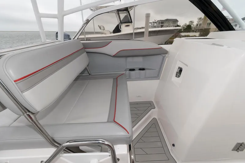 Slide: The Image of 2023 Solara S-250 DC boat interior with gray seating and red accents. - 11