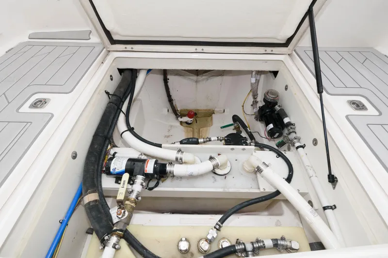 Slide: The Image of 2023 Solara S-250 DC boat engine compartment with visible hoses and mechanical components. - 18
