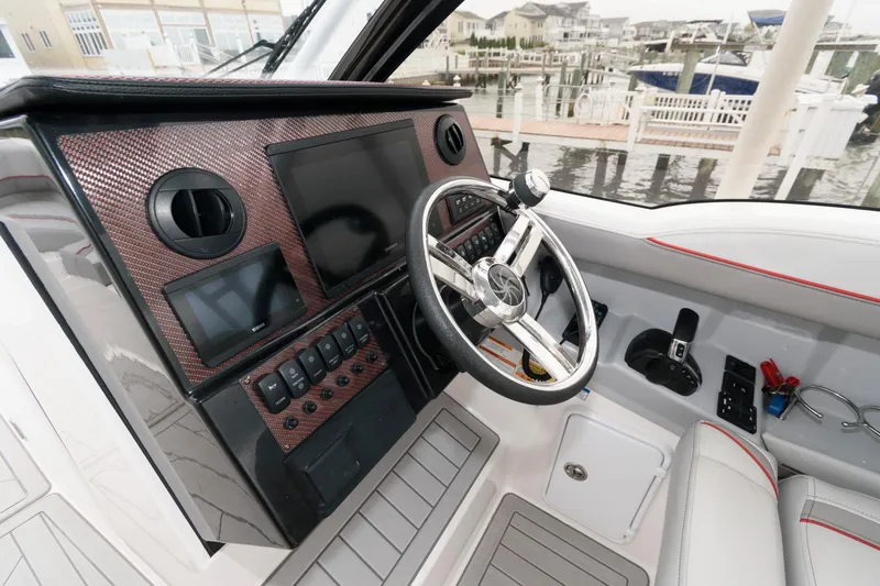 Slide: The Image of 2023 Solara S-250 DC boat dashboard with steering wheel and control panel. - 5