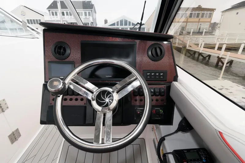 Slide: The Image of Helm of 2023 Solara S-250 DC boat with modern steering and control panel. - 6