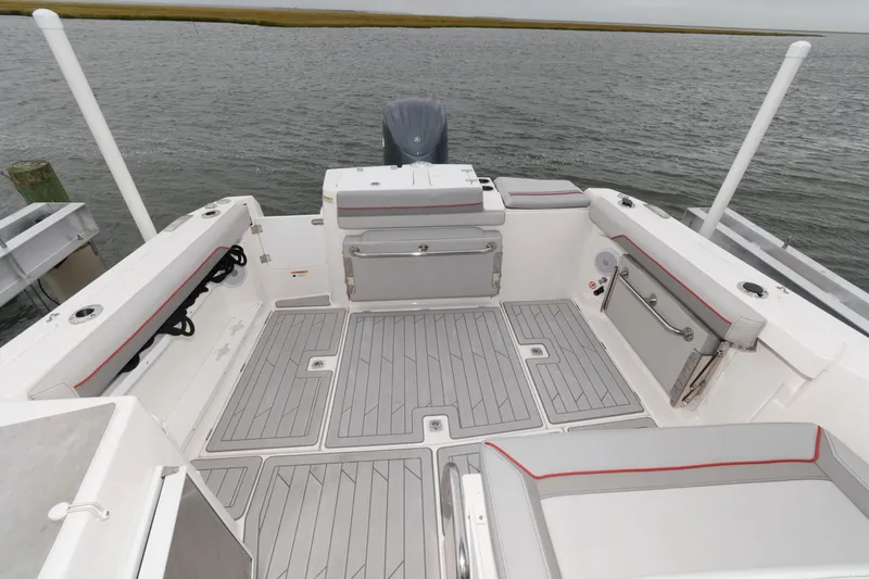 Slide: The Image of 2023 Solara S-250 DC boat deck with seating and storage, on calm water. - 8