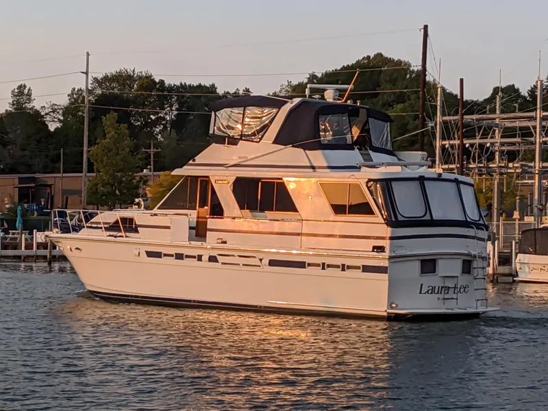 Slide: The Image of 1990 Jefferson Marquessa 52 yacht docked at sunset, reflecting golden light on water. - 1
