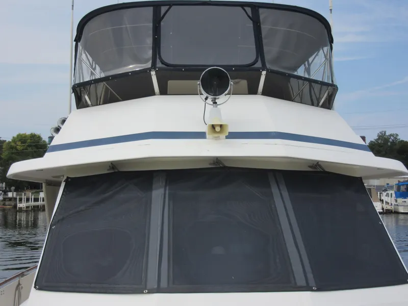 Slide: The Image of 1990 Jefferson Marquessa 52 yacht front view with tinted windows and upper deck. - 33