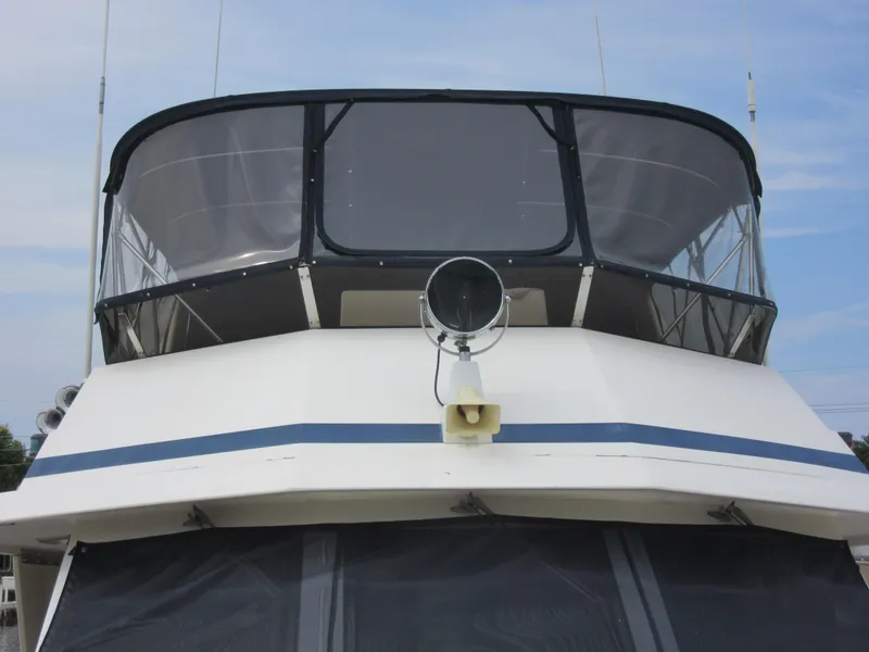 Slide: The Image of 1990 Jefferson Marquessa 52 yacht, front view with enclosed flybridge and radar. - 35