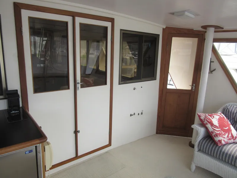 Slide: The Image of Interior of 1990 Jefferson Marquessa 52 yacht with doors and seating area. - 39