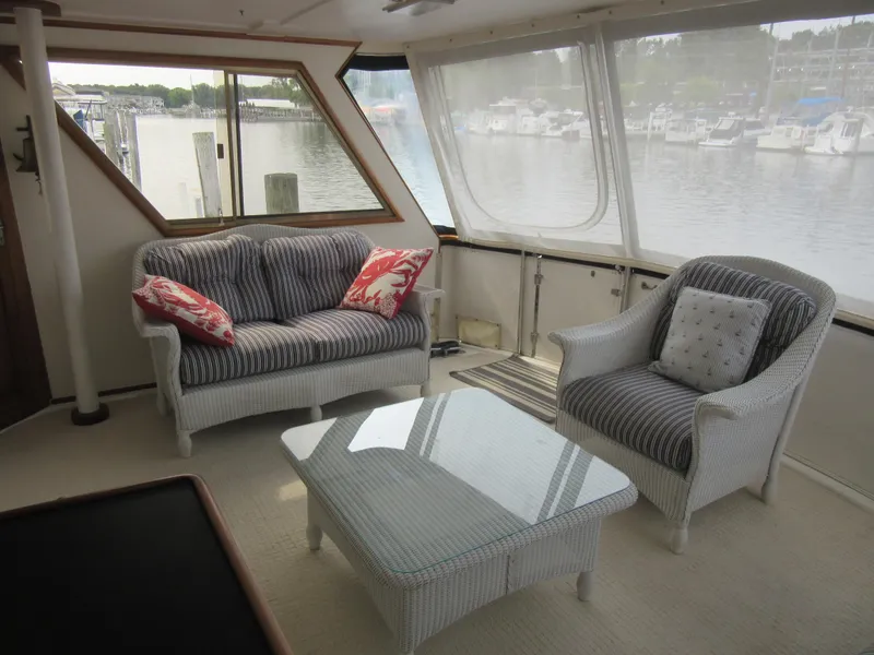 Slide: The Image of Interior of 1990 Jefferson Marquessa 52 yacht with wicker furniture and marina view. - 40