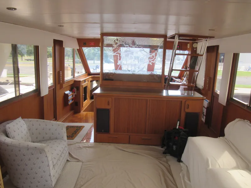 Slide: The Image of Interior of 1990 Jefferson Marquessa 52 yacht with wood paneling and comfortable seating. - 41