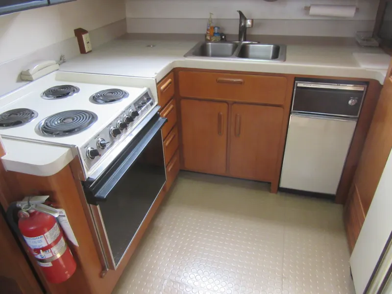 Slide: The Image of 1990 Jefferson Marquessa 52 yacht kitchen with stove, sink, and dishwasher. - 49