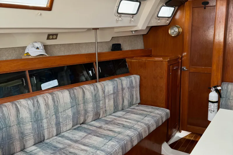 Slide: The Image of Interior of 1987 Hunter 31 sailboat with plaid seating and wooden cabinetry. - 5