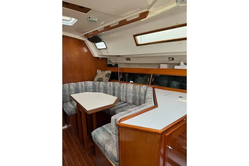 Slide: The Image of Interior of 1987 Hunter 31 sailboat with cozy seating and wooden finishes. - 9