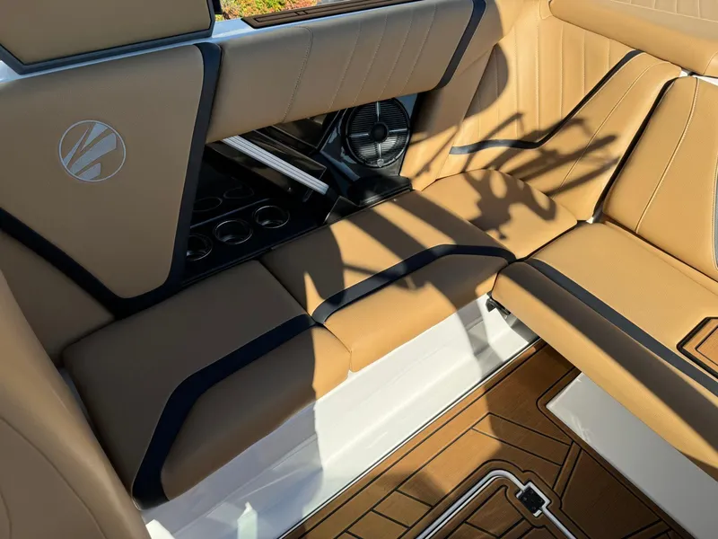 Slide: The Image of 2020 Tigé 23 RZX interior with tan upholstery and cup holders. - 11