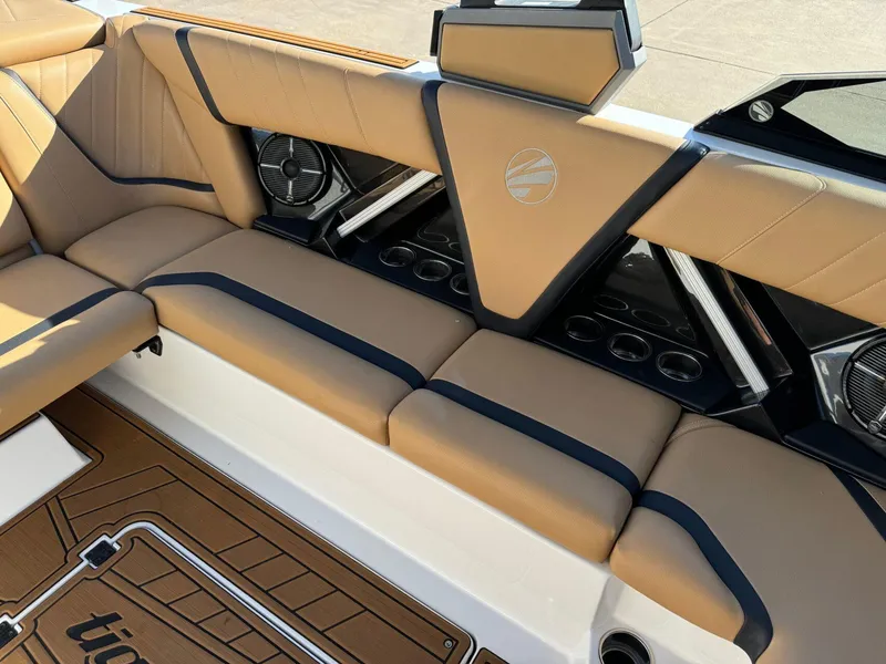 Slide: The Image of 2020 Tigé 23 RZX boat interior with tan seating and cup holders. - 12