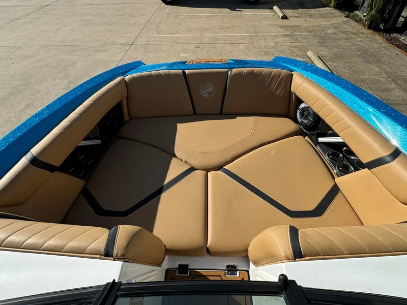 Slide: The Image of 2020 Tigé 23 RZX boat interior with tan seating and blue exterior. - 15