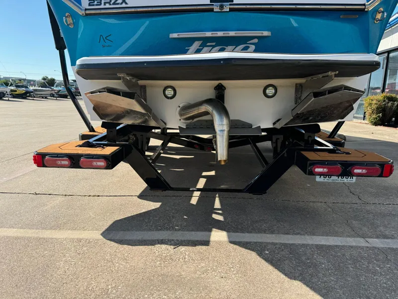 Slide: The Image of Rear view of a 2020 Tigé 23 RZX boat on a trailer in a parking lot. - 3