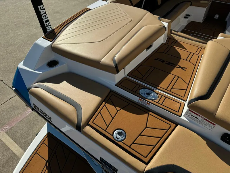 Slide: The Image of 2020 Tigé 23 RZX boat interior with tan seating and deck details. - 5