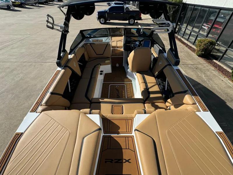 Slide: The Image of 2020 Tigé 23 RZX boat interior with tan seating and sleek design. - 9
