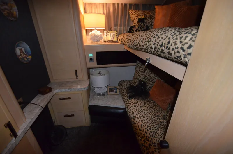 Slide: The Image of 1989 Silverton Aft Cabin 46 interior with leopard print bedding and cozy lighting. - 10
