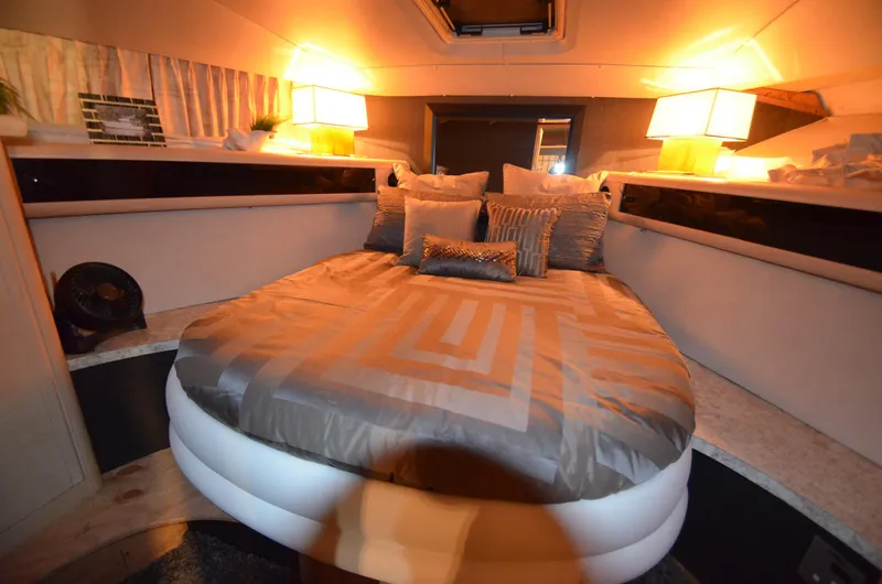 Slide: The Image of Luxurious cabin interior of 1989 Silverton Aft Cabin 46 yacht with cozy bedding and ambient lighting. - 11