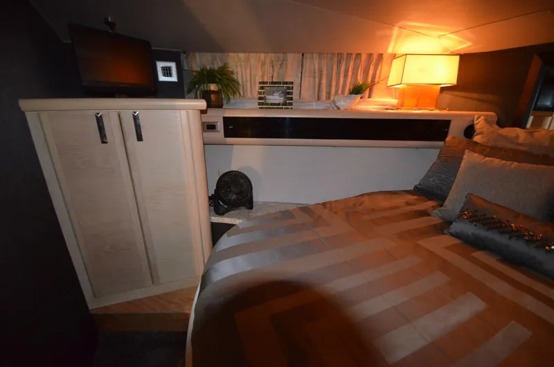 Slide: The Image of 1989 Silverton Aft Cabin 46 interior with cozy bed, ambient lighting, and modern decor. - 12