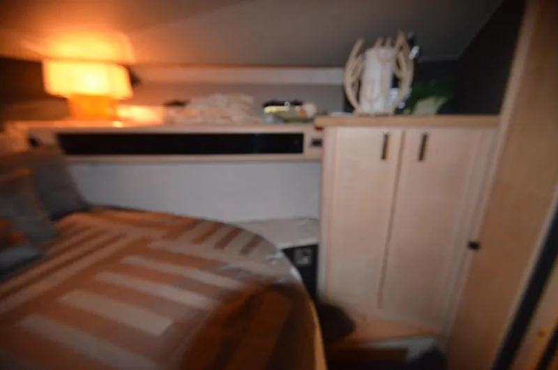 Slide: The Image of Cozy cabin interior of 1989 Silverton Aft Cabin 46 with warm lighting. - 13