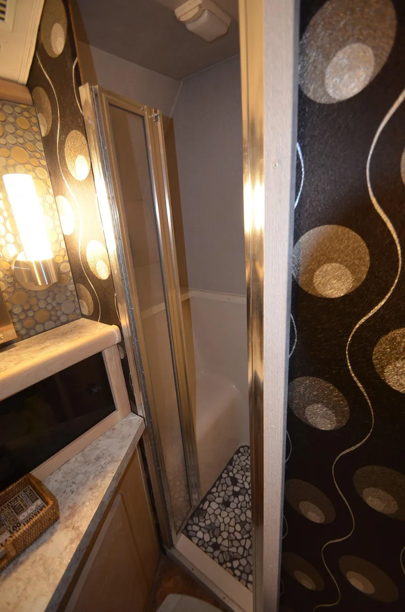 Slide: The Image of 1989 Silverton Aft Cabin 46 bathroom with modern shower and stylish decor. - 15