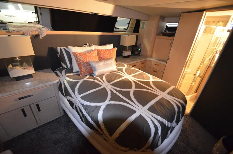 Slide: The Image of 1989 Silverton Aft Cabin 46 bedroom with modern decor and cozy lighting. - 19