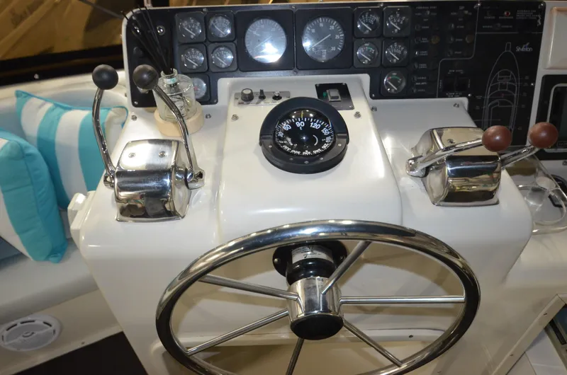 Slide: The Image of Control panel of a 1989 Silverton Aft Cabin 46 yacht with steering wheel and gauges. - 29