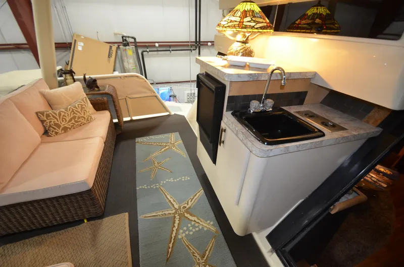 Slide: The Image of 1989 Silverton Aft Cabin 46 interior with kitchenette and seating area. - 33