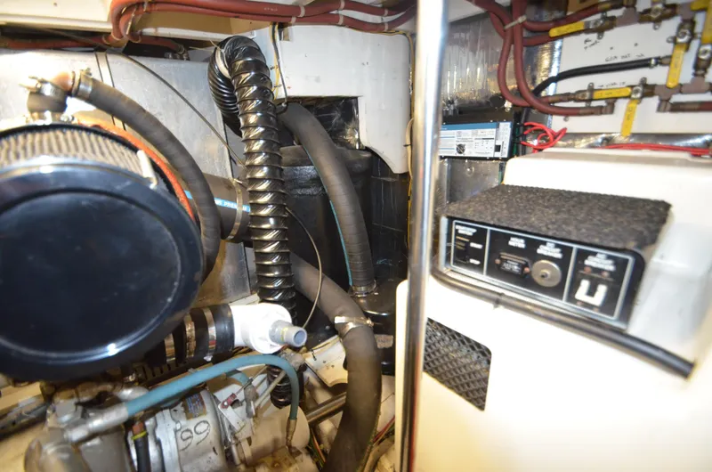 Slide: The Image of Engine room of 1989 Silverton Aft Cabin 46 with visible components and wiring. - 39