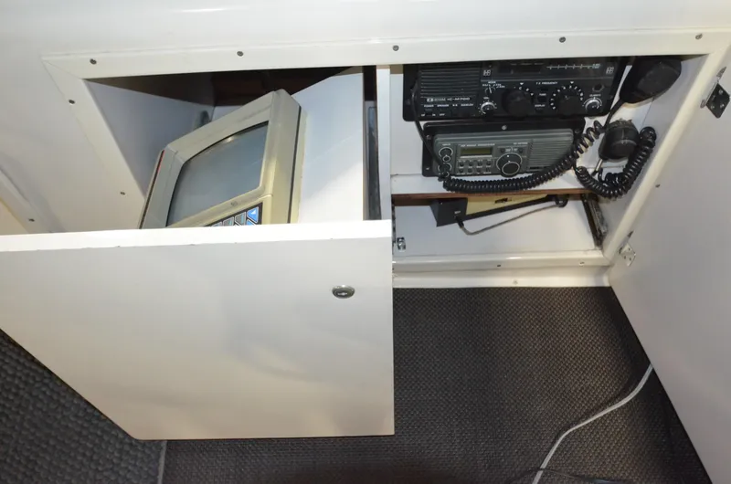 Slide: The Image of 1989 Silverton Aft Cabin 46 interior with vintage electronics and communication equipment. - 49